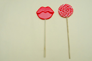 two lollipops on a beige background