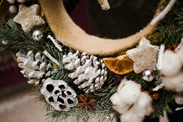 Christmas wreath with cones, dried oranges and cotton