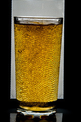 glass of beer on dark background,glass of cold beer on the table. object on a black background, а...