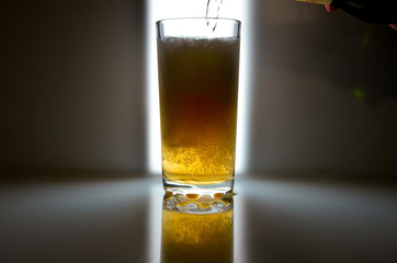 glass of beer on dark background,glass of cold beer on the table. object on a black background, а...