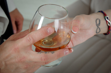 hand with glass of white wine
