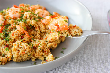 Grits cous cous with vegetables and grilled shrimp