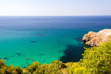 Landscape sea waves line impact rock on the beach. Stones at the beach with wave and nice blue sky. turquoise water