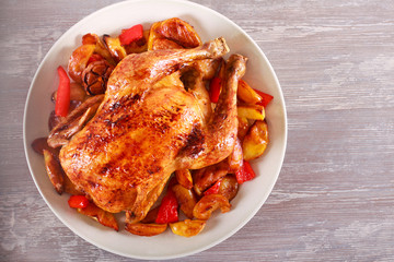 Baked chicken with vegetables on plate