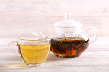 Pouring hot herbal tea in a cup