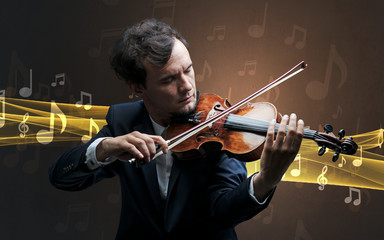 Young male musician playing on his violin with musical notes around