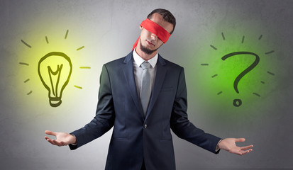 Covered eye businessman with bulb and question sign symbols around
