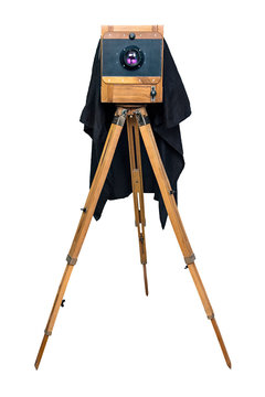 old wooden camera on a tripod isolated on white background