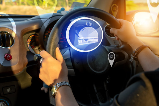 Closed Up Of Hands Driving In The Car With Modern Virtual Screen Augmented Reality Navigation Direction For Destination .Futuristic Car Driving Technology Concept .