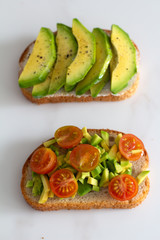 toast with avocado and tomatoes close up.
