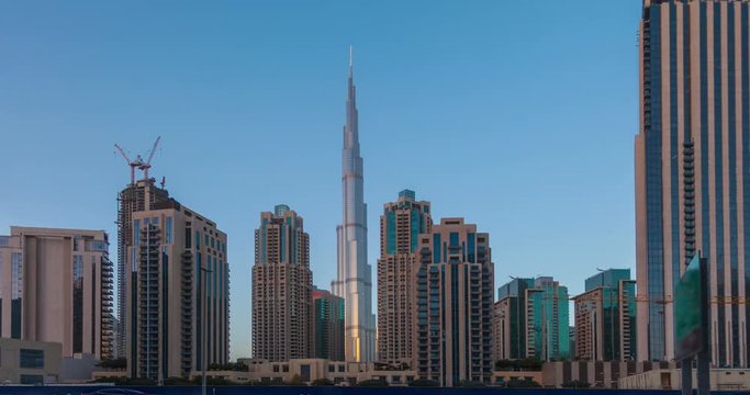 Panorama of skyscrapers and Burj Khalifa tower from day to night. Time Lapse.