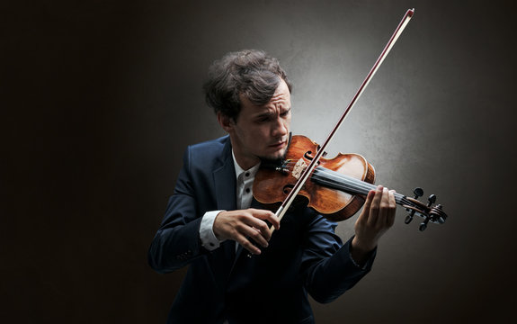 Lonely violinist composing on cello with nothing around
