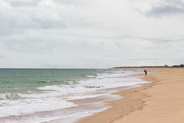 Sandy beach before the rain. Dark clouds over the ocean and the beach.