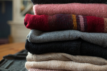 Pile of colorful sweaters close up.
