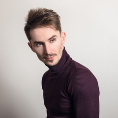 Fototapeta premium Handsome young elegant man in violet golf.