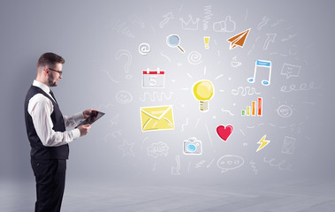 Young manager presenting new plan  illustrated by colourful chalk drawn icons and symbols around
