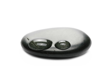 Spa stones with water drops macro isolated on white