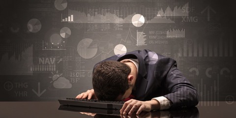 Young businessman sleeping with charts, graphs and reports on the background
