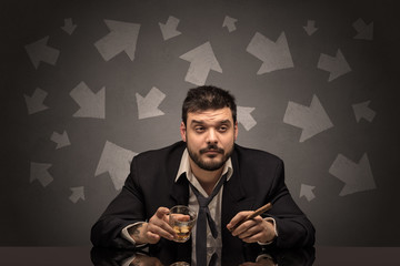 Drunk disappointed man sitting at table with arrows around
