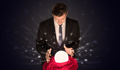 Fototapeta premium Gorgeous businessman looking to inspiration in a magic ball in his lap and doodle concept 
