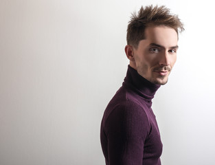 Fototapeta premium Handsome young elegant man in violet golf.