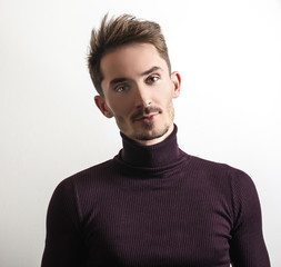 Handsome young elegant man in violet golf.