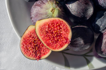 Ripe sweet figs. Fresh figs fruit on a plate close up/macro