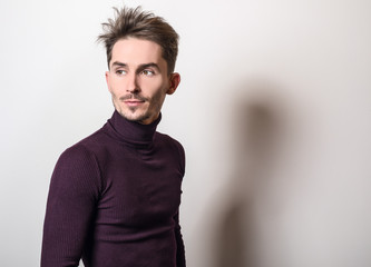 Obraz premium Handsome young elegant man in violet golf.