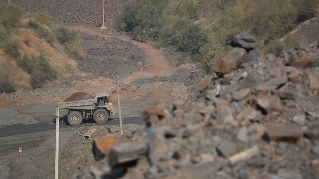 Quarry, mining of iron ore. Coming belaz refocus in the foreground ore.