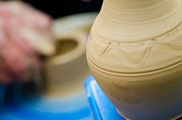 Street master class on modeling of clay on a potter's wheel In the pottery workshop