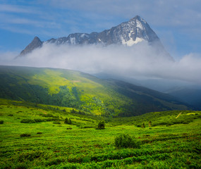 beautiful green mountain valley before the lonely mountain in a clouds, fantasy landscape