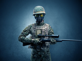 Soldier agent in a dark room with arms on his hand and gas mask
