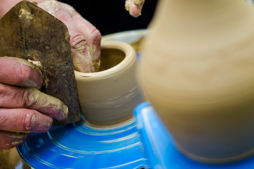 Street master class on modeling of clay on a potter's wheel In the pottery workshop