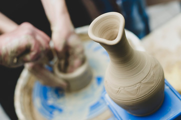 Street master class on modeling of clay on a potter's wheel In the pottery workshop
