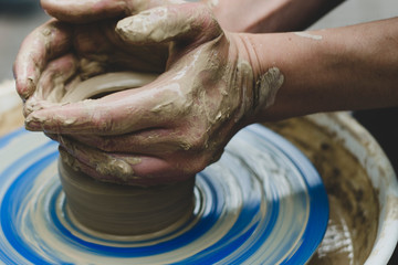 Street master class on modeling of clay on a potter's wheel In the pottery workshop