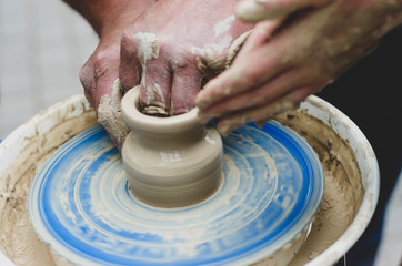 Street master class on modeling of clay on a potter's wheel In the pottery workshop