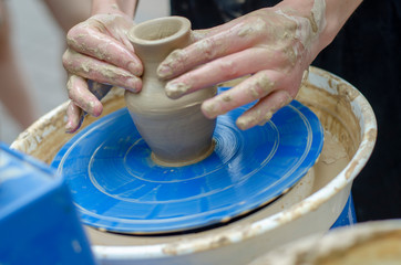 Street master class on modeling of clay on a potter's wheel In the pottery workshop