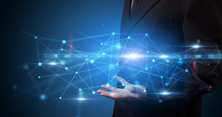 Handsome person holding hologram screen displaying modern cloud based web system technology
