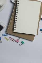 White office desk,  computer keyboard, mobile phone and other office supplies on table. Top view with copy space, flat lay.