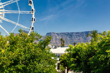 Ferris wheel and Table Mountain view at Waterfront in Cape Town
