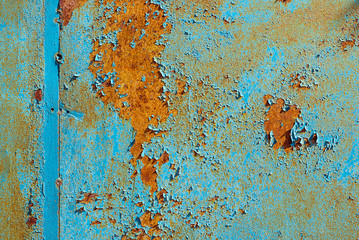 Texture of old rusty metal, painted blue which becames orange from rust. Horizontal texture of cracked paint on rusty steel
