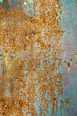 Texture of old rusty metal, painted white which becames orange from rust. Vertical texture of cracks and peels paint on rusty steel