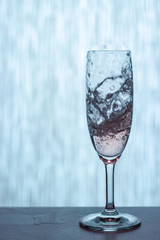 a splash in a glass of white wine and whiskey
