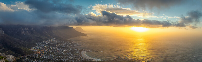 Lion's head top panoramic view of Table Mountain and Cape Town city at sunset with beatiful clouds in the sky