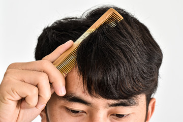 Close up photo of man is combing hair