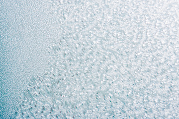 Frozen winter abstract background on the window glass with copy space