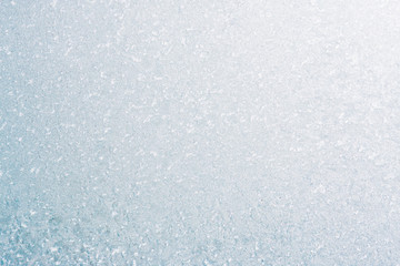 Fototapeta premium Frozen winter abstract background on the window glass with copy space