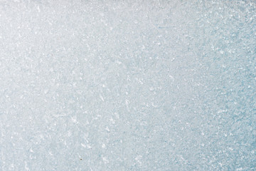 Winter background with gleaming ice. Frozen water texture. Copy space