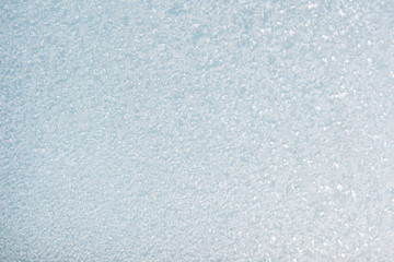 Winter background with gleaming ice. Frozen water texture. Copy space