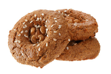 A bunch of homemade oatmeal cookies with nuts, chocolate and sesame. Isolated on white background.